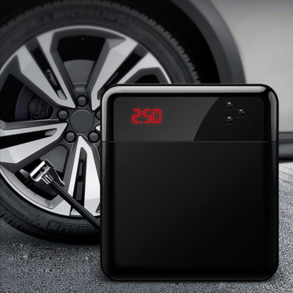 Shown on the photo is a car tire air compressor Inflating a tire