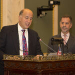 Speakers at a city council meeting
