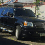 Black Ford Expedition SUV with running boards