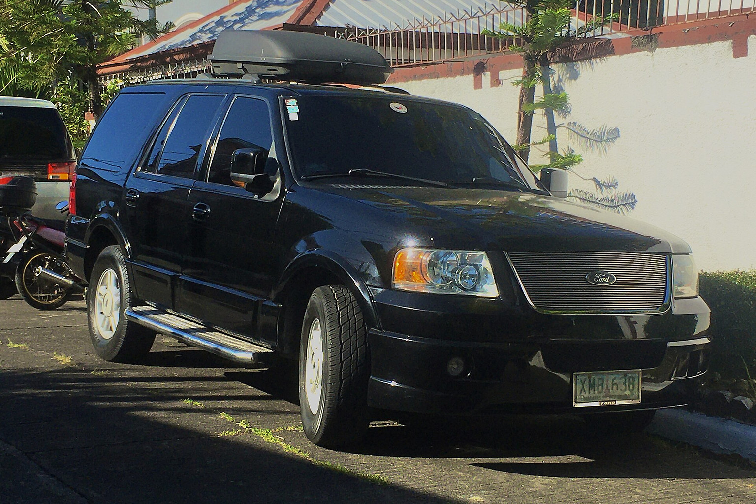 Black Ford Expedition SUV with running boards