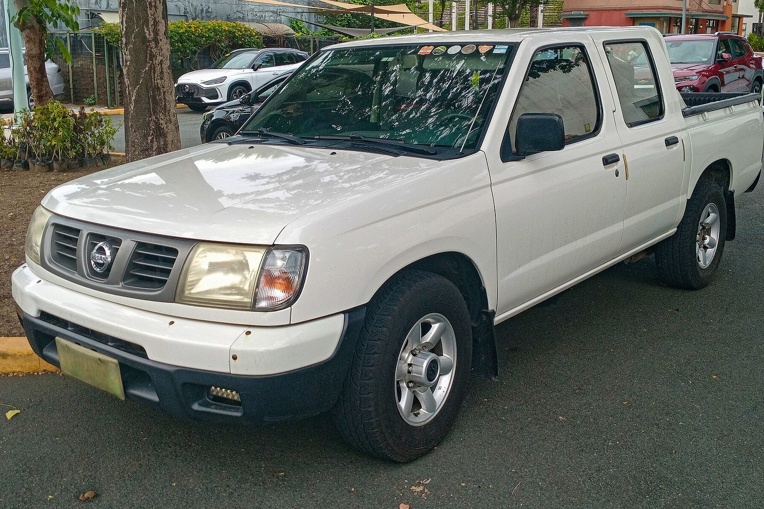 White Nissan Frontier pickup truck shown from the front left