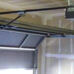 Chain-drive garage door opener mounted above a residential garage door