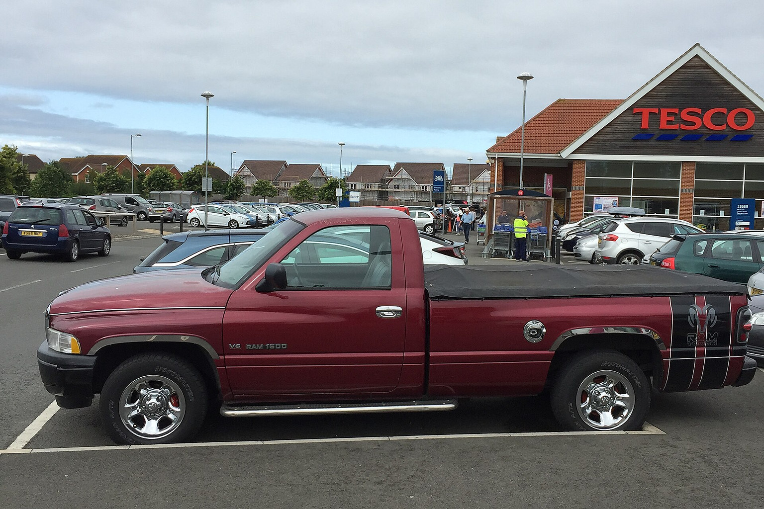 Red Dodge Ram 1500 pickup truck in side view