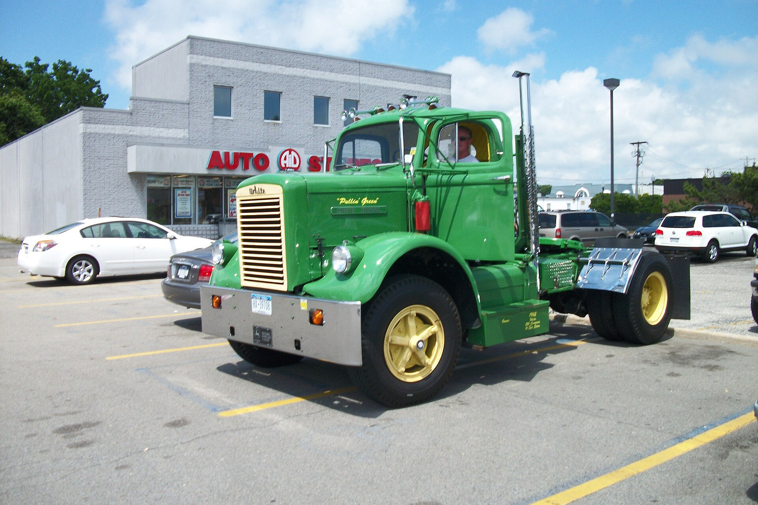 Green vintage truck shown from a front three-quarter view
