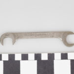 Open-end carburetor wrench on a measurement background